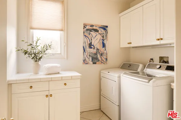 a view of storage and utility room with washer and dryer