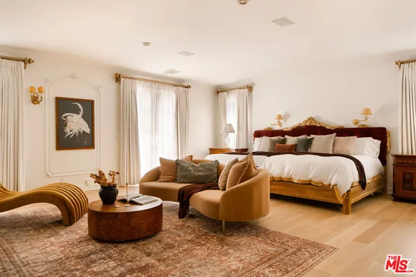 a bedroom with a bed and couch