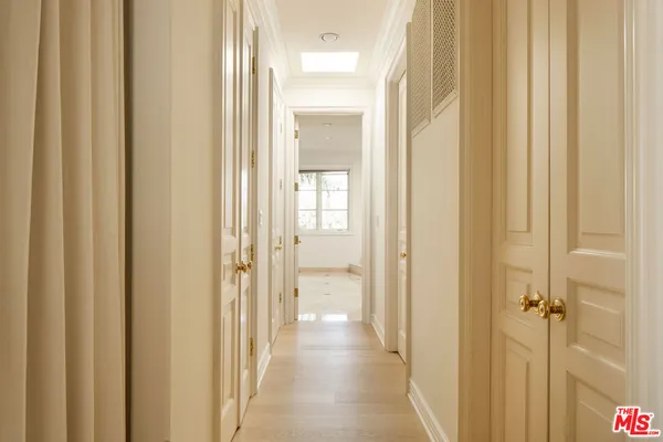 a view of a bathroom from a hallway with wooden door