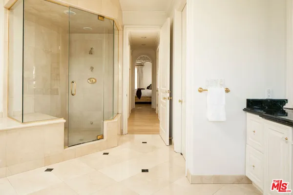 a bathroom with a bathtub shower and sink