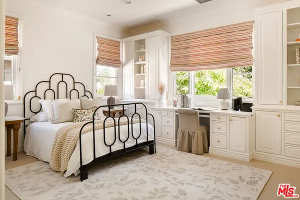 a spacious bedroom with a large bed and a large window