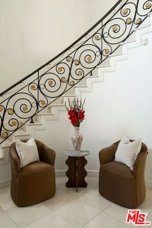 a view of entryway with furniture and a chandelier