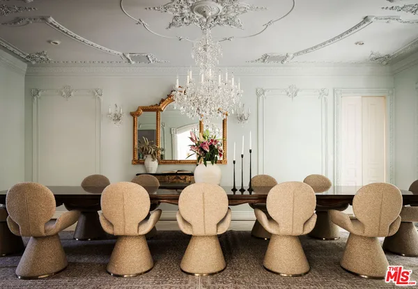 a dining room with furniture and chandelier