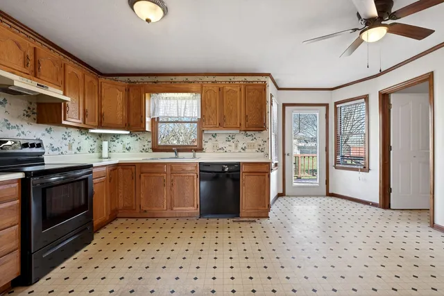 a kitchen with stainless steel appliances granite countertop a stove sink and cabinets