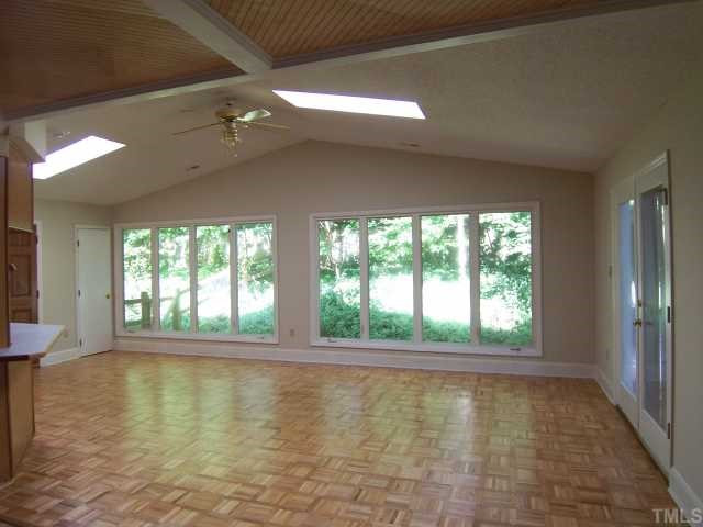 3232 Lewis Farm Road Raleigh, NC 27607 - Photo 2 of 5 Beautiful hardwoods in the living room full of light from the windows and skylights! Open feel and raised celings! Living Room