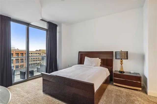 a bedroom with a large bed and a large window