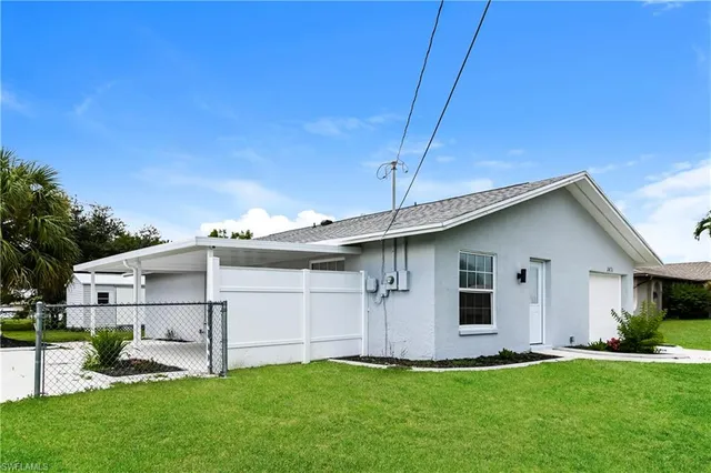 a front view of house with a garden