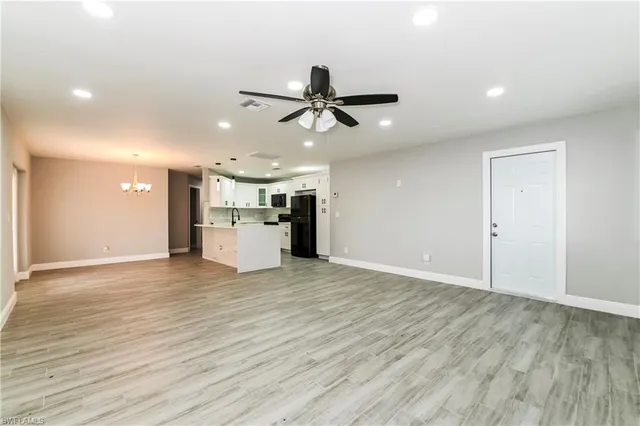 a view of a kitchen with a sink and a refrigerator