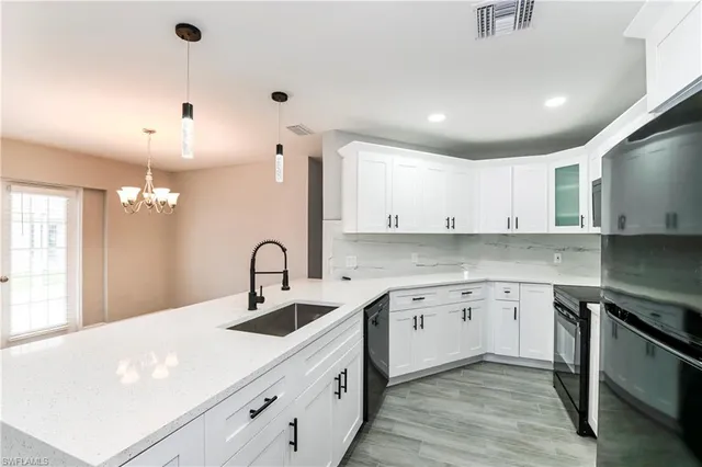 a kitchen with a sink cabinets and window
