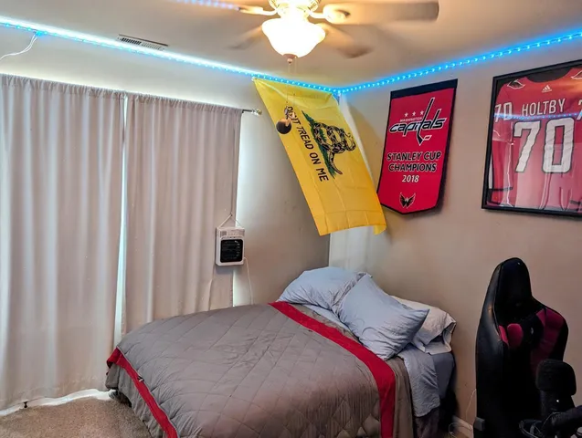 a bedroom with a bed and a chandelier