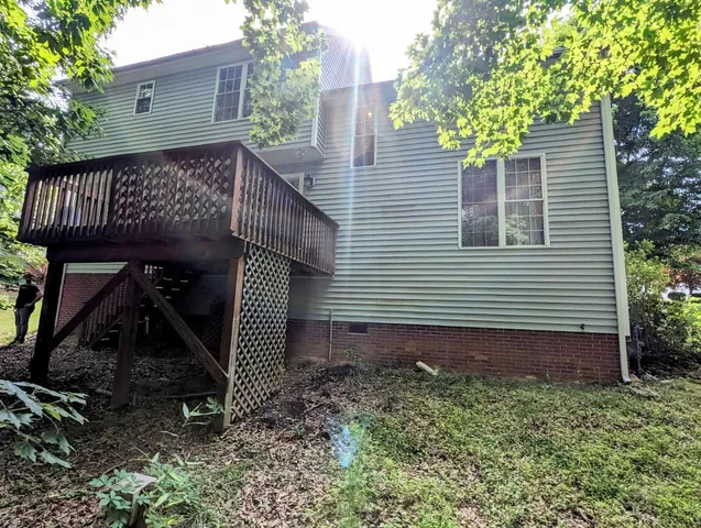 a view of a house with a yard and potted plants