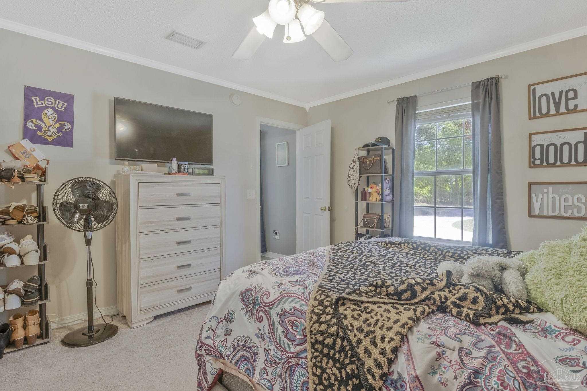 5539 Windrun Place Pace, FL 32571 - Photo 27 of 62 a bedroom with a bed and a window