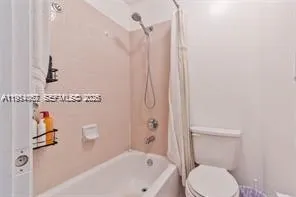 a view of a room with furniture and a ceiling fan