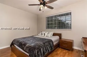 a white house that has a tree in front of it