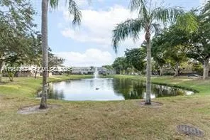a view of a field of grass and trees