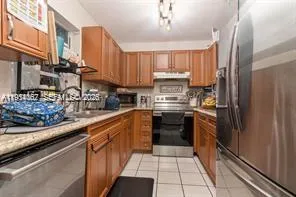 a kitchen with stainless steel appliances a refrigerator sink and cabinets