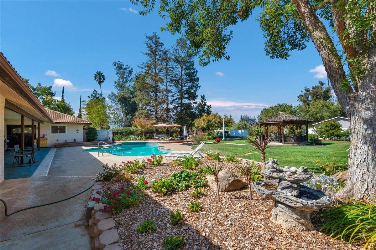 41071 Adobe Way Madera, CA 93636 - Photo 1 of 27 a view of a garden with lawn chairs