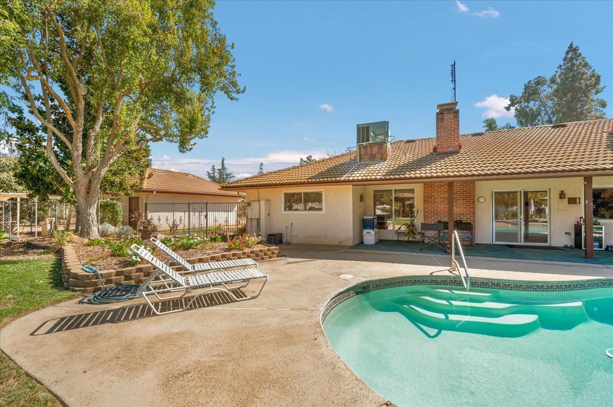 41071 Adobe Way Madera, CA 93636 - Photo 11 of 27 a front view of a house with a yard table and chairs