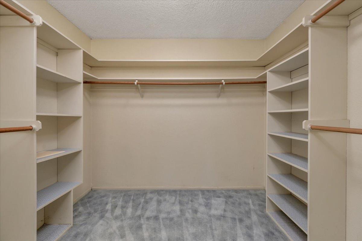 41071 Adobe Way Madera, CA 93636 - Photo 16 of 27 a view of walk in closet with empty racks