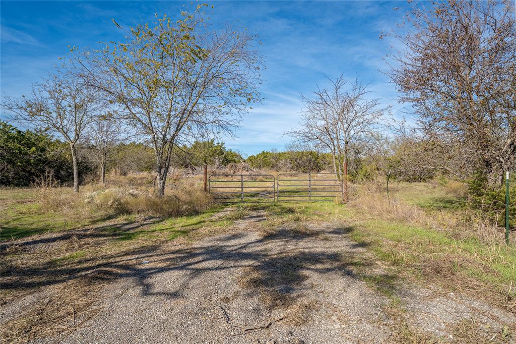 693 Garrett Lane China Spring, TX 76633 - Photo 13 of 16 a view of dirt yard with a large tree
