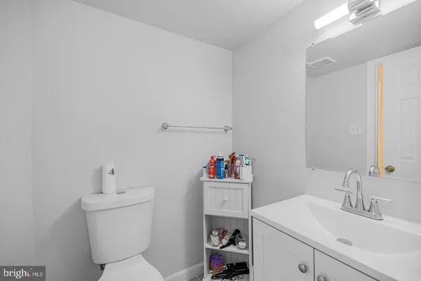 a bathroom with a sink toilet vanity and tub