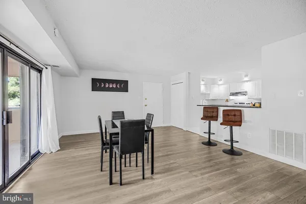 a view of a room with furniture and wooden floor