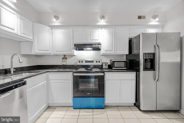 a kitchen with a sink cabinets and stainless steel appliances