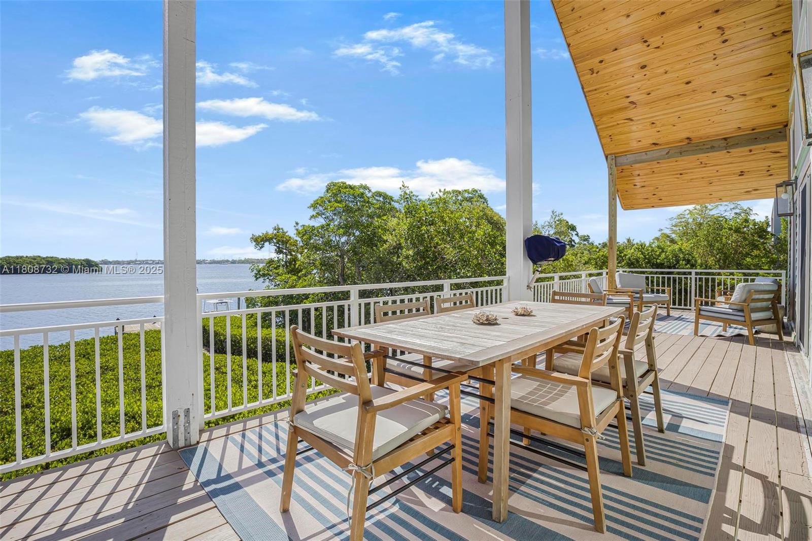 41 Mutiny Place Key Largo, FL 33037 - Photo 12 of 69 a view of a balcony with wooden floor and fence