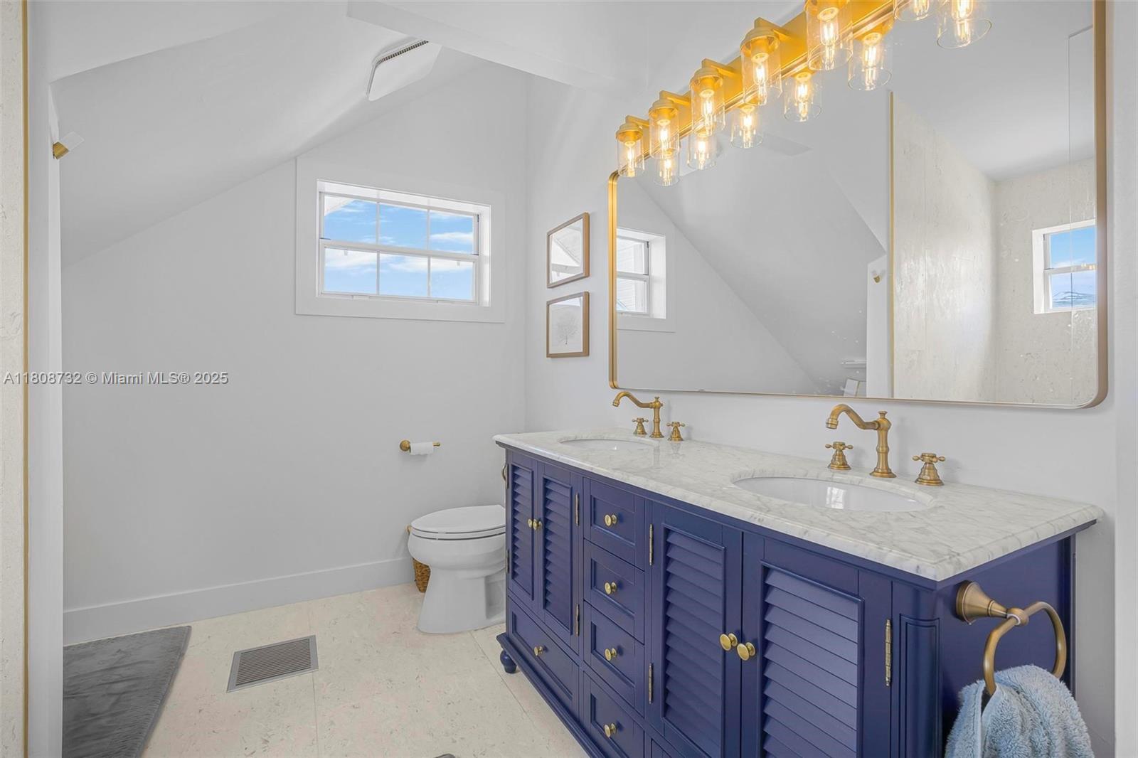 41 Mutiny Place Key Largo, FL 33037 - Photo 33 of 69 a bathroom with a toilet a sink and mirror