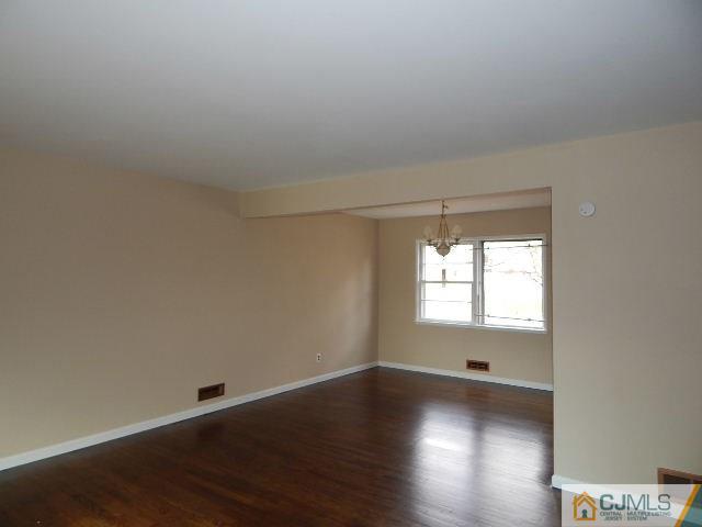 5 Amman Road Edison, NJ 08817 - Photo 14 of 24 an empty room with wooden floor and windows
