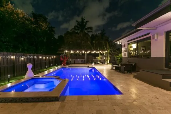 a view of swimming pool with red chairs