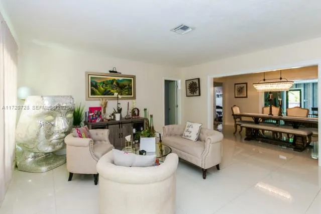 a living room with furniture pool table and a flat screen tv