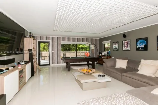 a view of living room with patio furniture and potted plants