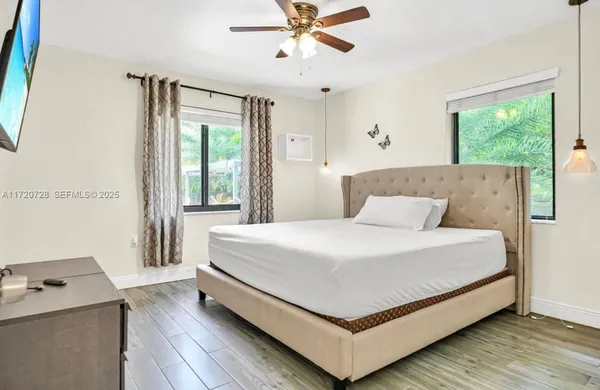 a bedroom with a bed and window