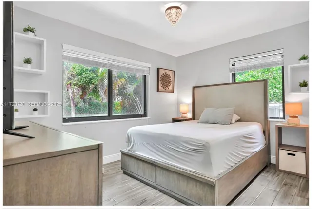 a view of swimming pool with seating space and potted plants