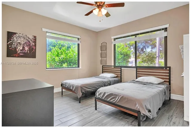a view of a patio with a dining table and chairs under an umbrella