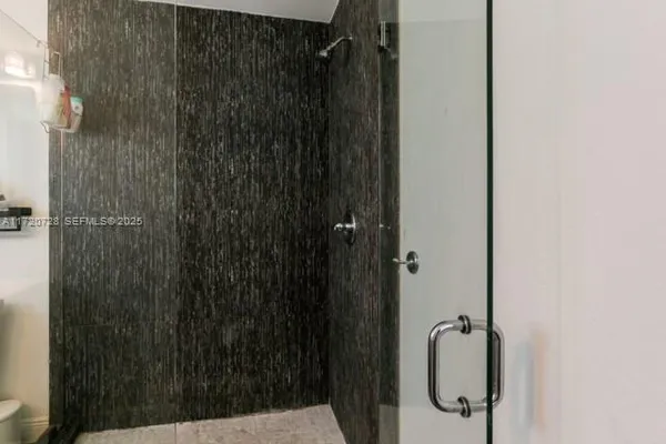 a bathroom with a shower and a sink