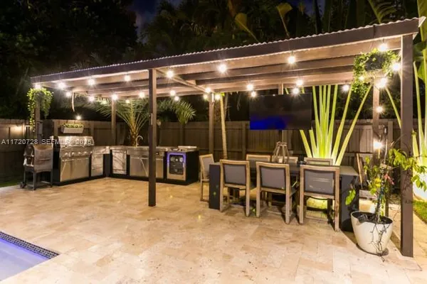 a view of living room with patio furniture and potted plants