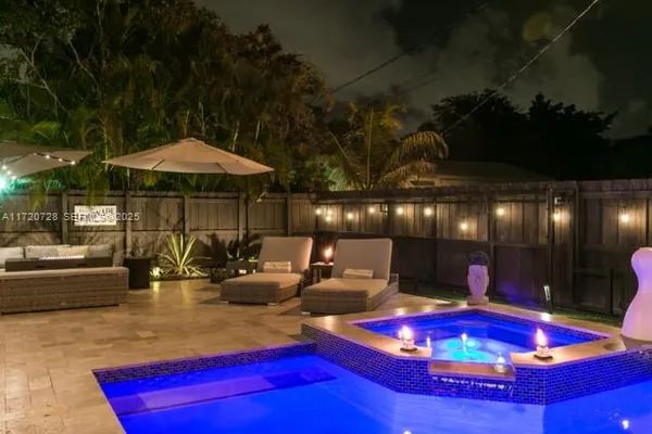 a view of swimming pool with seating space