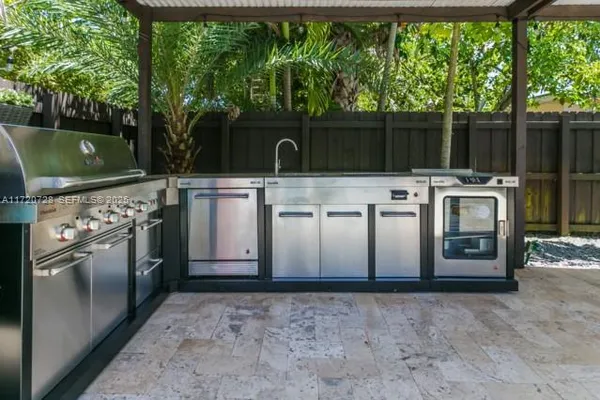 a view of a kitchen with a stove top oven cabinetry and a fountain