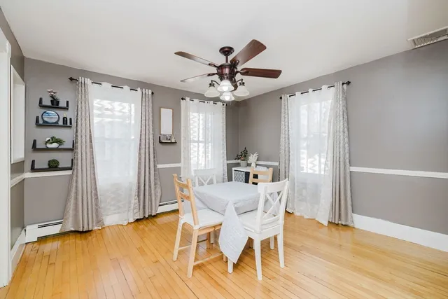 a view of a dining room with furniture and a window