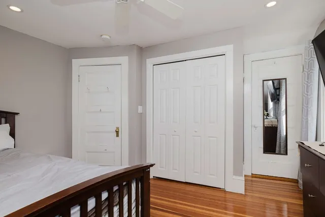 a view of a hallway with wooden floor and cabinet