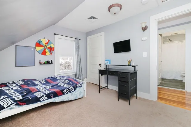 a bedroom with a bed and a television