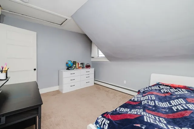 a bedroom with a bed and a dresser in it