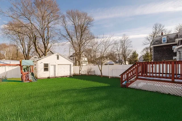 a view of a house with a yard and a deck