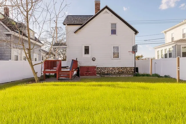 a view of a swimming pool with chairs and fire pit