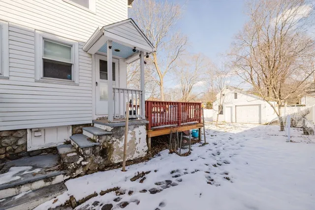 a view of a house with a wooden fence