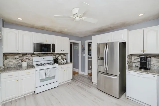 a kitchen with stainless steel appliances a refrigerator stove and microwave