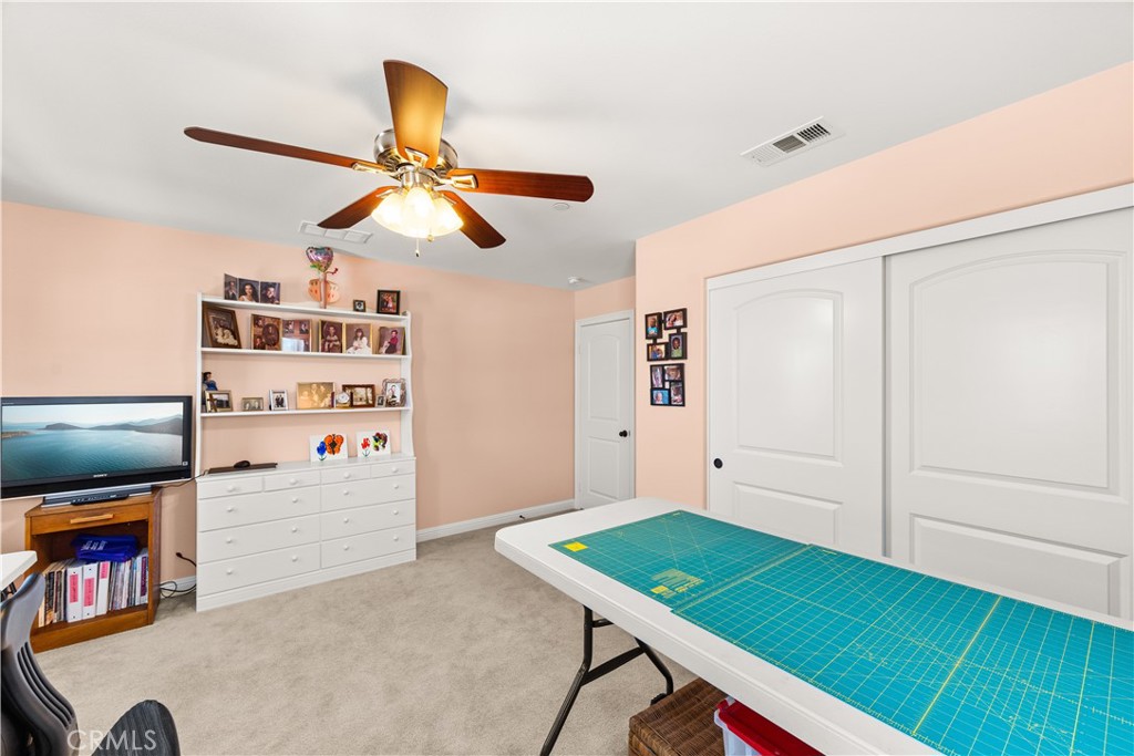 4976 Golden Ridge Place Rancho Cucamonga, CA 91739 - Photo 28 of 56 Upstairs bed 2 used as a craft room with lighted ceiling fan and plush carpet