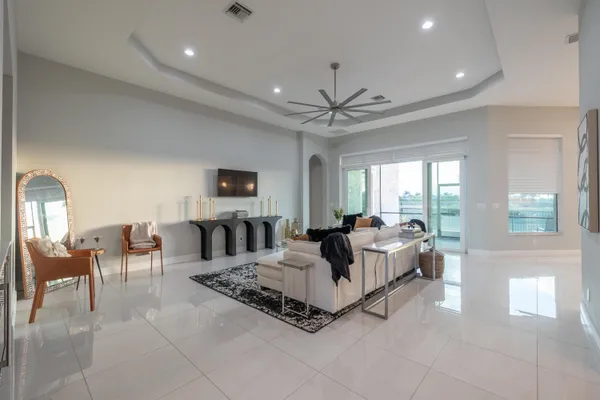 a kitchen with kitchen island granite countertop a sink a center island a refrigerator and a counter top space